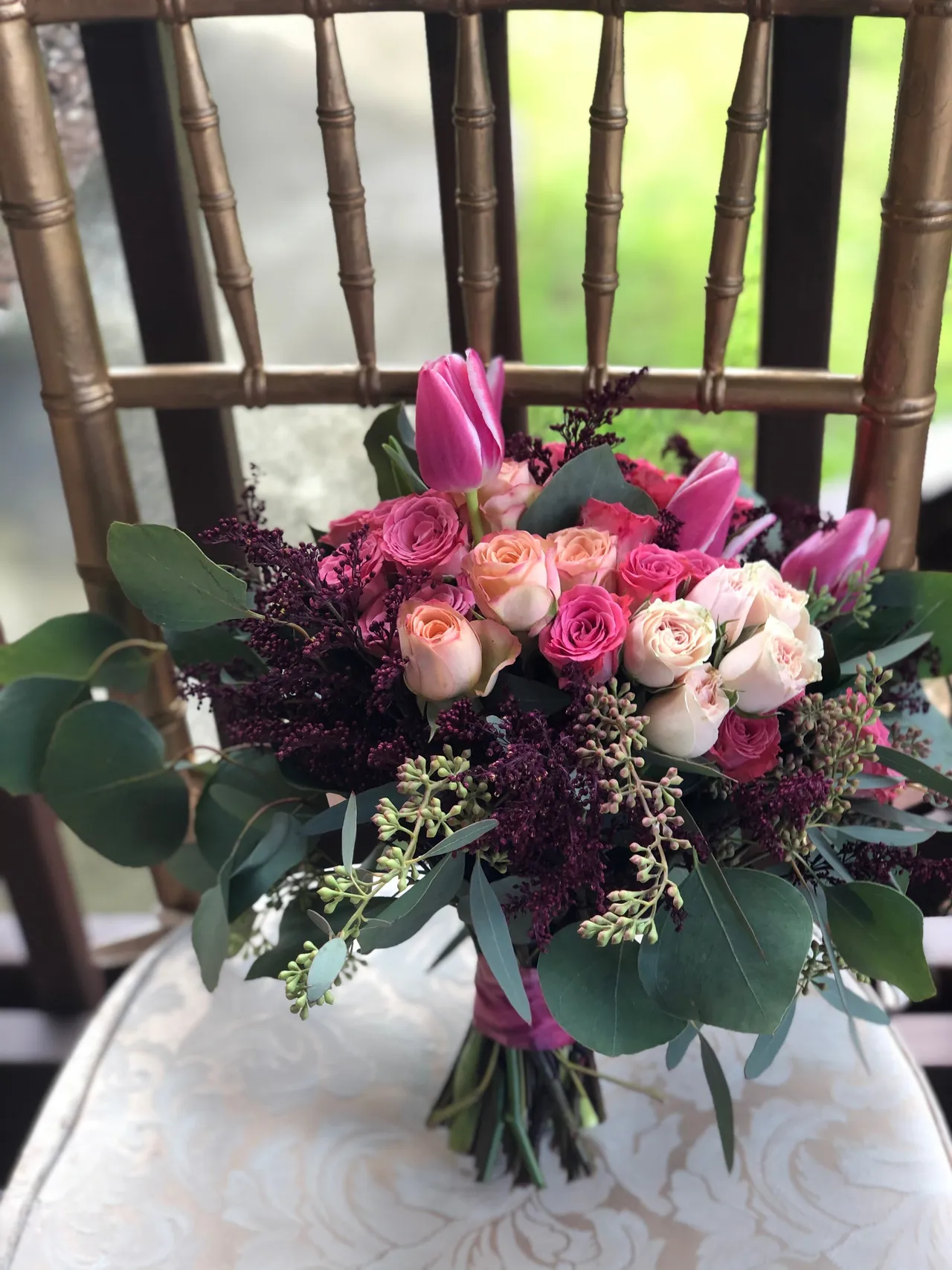 A delicate medley of pink roses and vibrant tulips, elegantly tied together in a symphony of color.