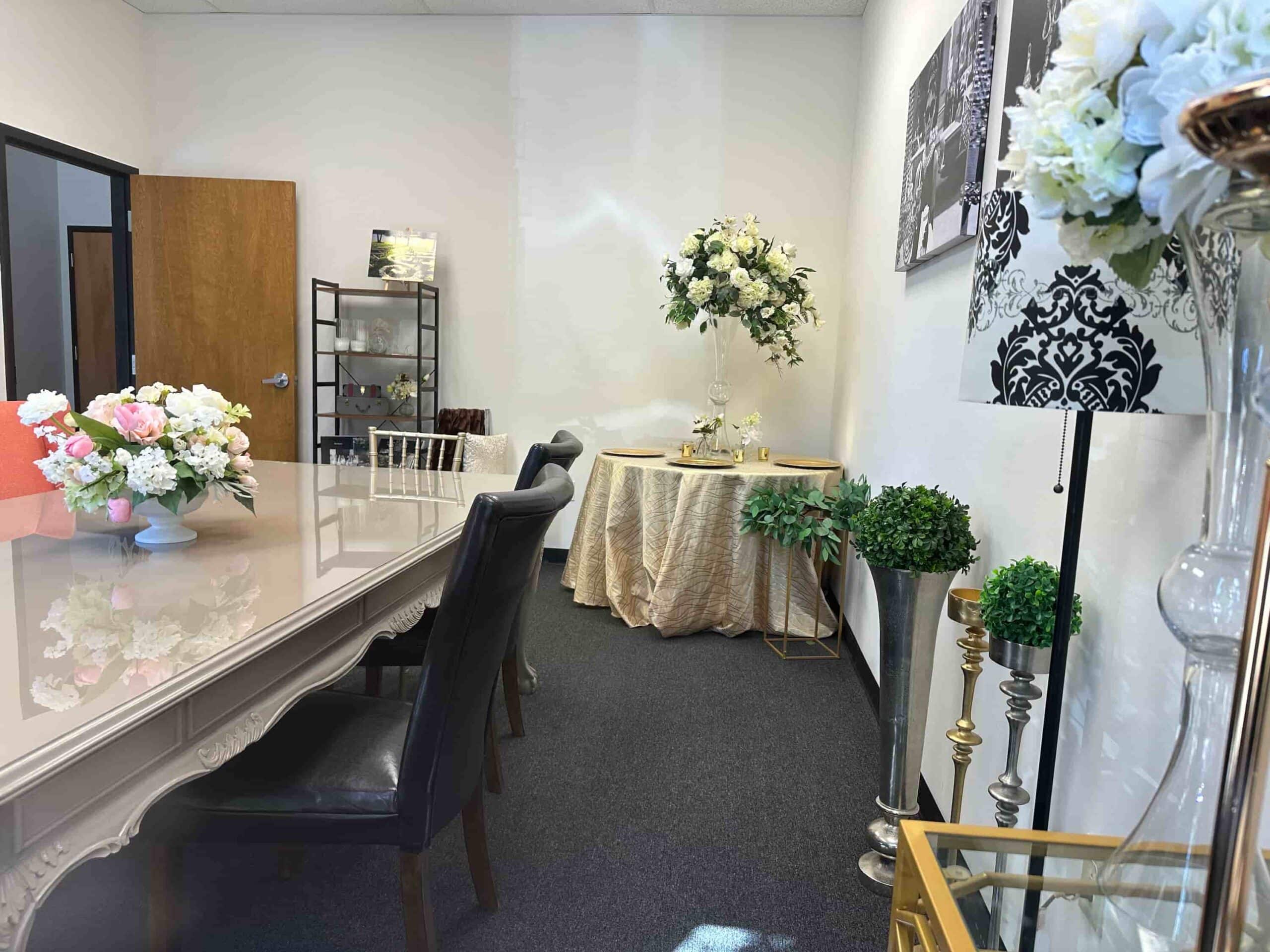 Flowers By Impressions Suwanee office with a beautifully decorated table, floral arrangements, and elegant decor elements