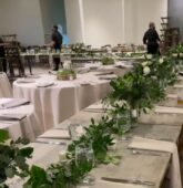 Elegant wedding reception table featuring a lush greenery table runner and white napkins at The Stave Room, Atlanta.