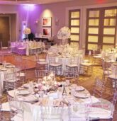 Elegant wedding reception at Villa Christina in Atlanta with pink and white floral centerpieces and purple uplighting.