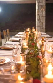 Guest wedding table arrangement with candlelit centerpiece.