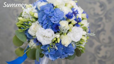 Summer flower bouquet with blue hydrangeas, white roses, and greenery.